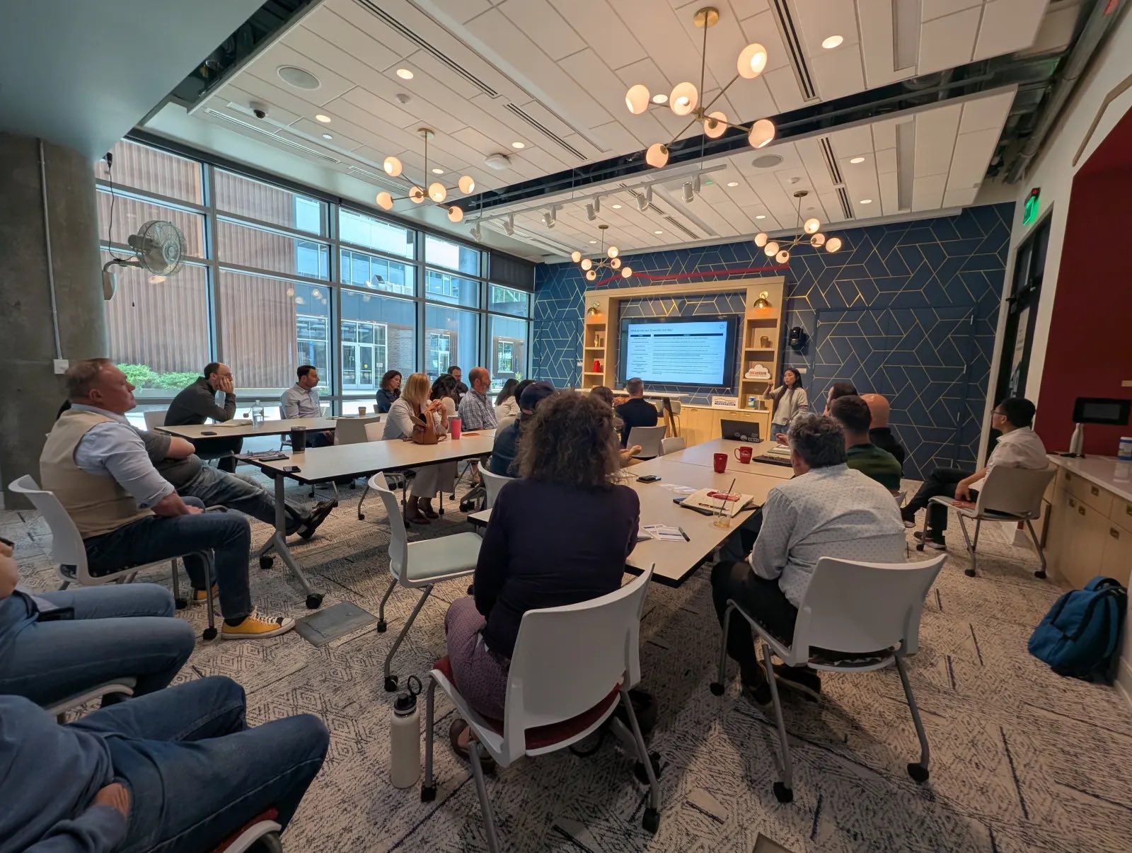 A full room of AAIG members at a bi-monthly forum session in Madison