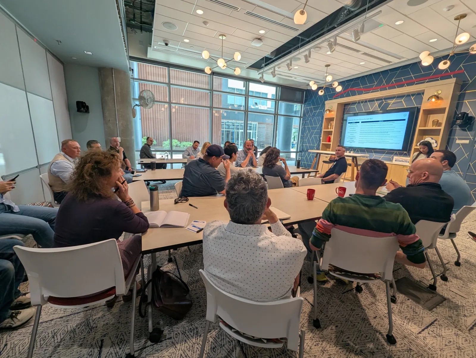 AAIG members seated around working tables during a bi-monthly forum session in Madison